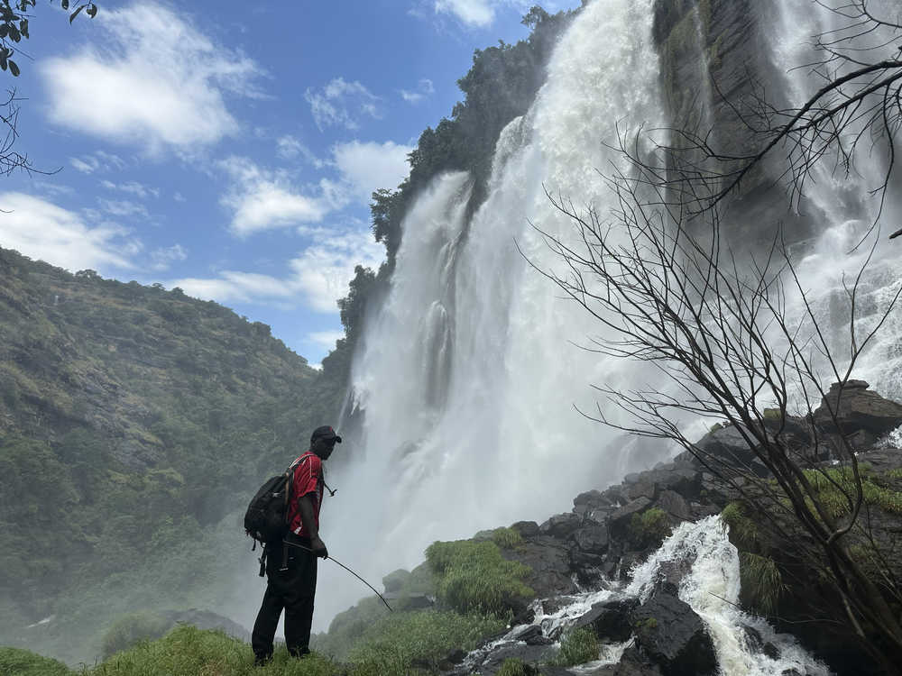 Guide devant la chute de Kamawi en Guinée