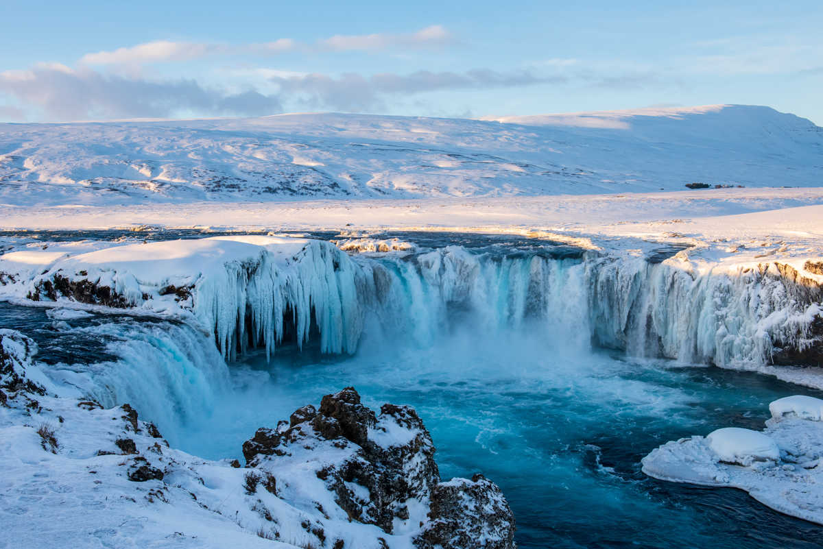 Frozen Godafoss waterfall on cold winters day at dawn, Northern Iceland