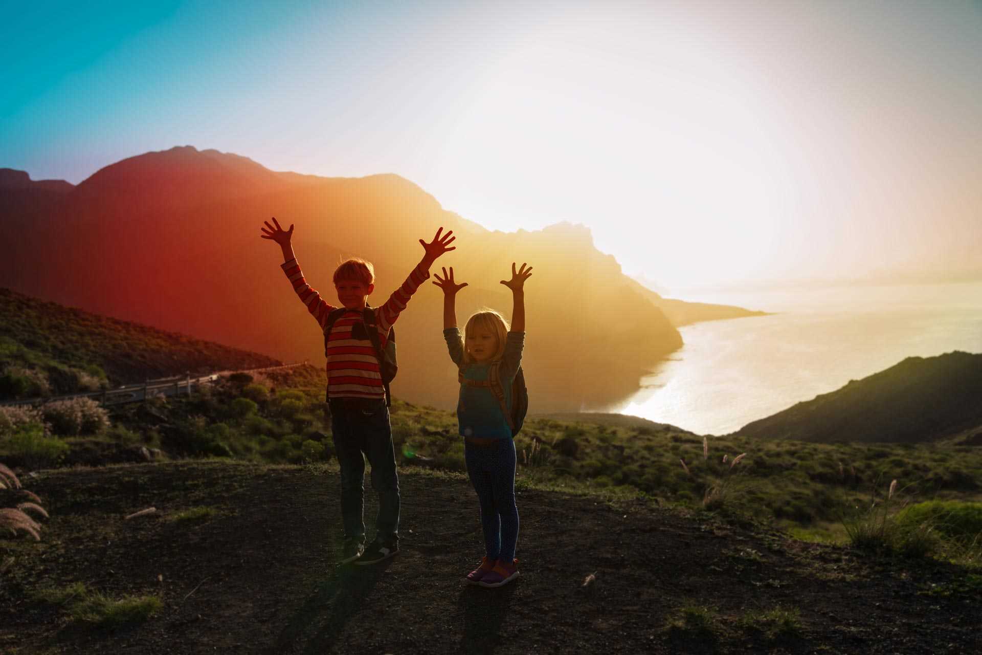 Enfants réjouis devant un coucher de soleil sur l'île de Tenerife