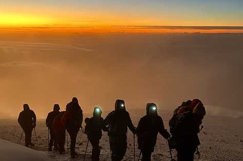 groupe de randonneurs de nuit pendant l'ascension du Kilimandjaro en Tanzanie