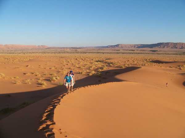 Hommes marchant dans les dunes de Erg Chebbi de Merzouga au Maroc