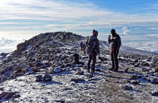 Deux randonneurs lors d'une petite pause au sommet du Kilimandjaro en Tanzanie